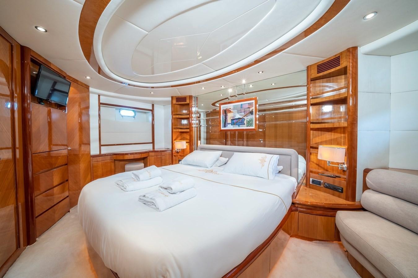 a room with a bed and a tv on the wall aboard D FLAWLESS Yacht for Sale