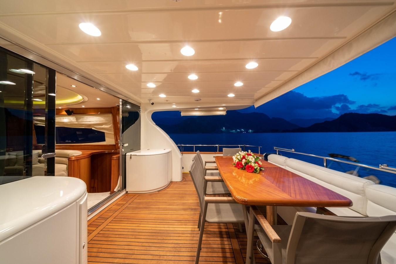 a room with a table and chairs aboard D FLAWLESS Yacht for Sale