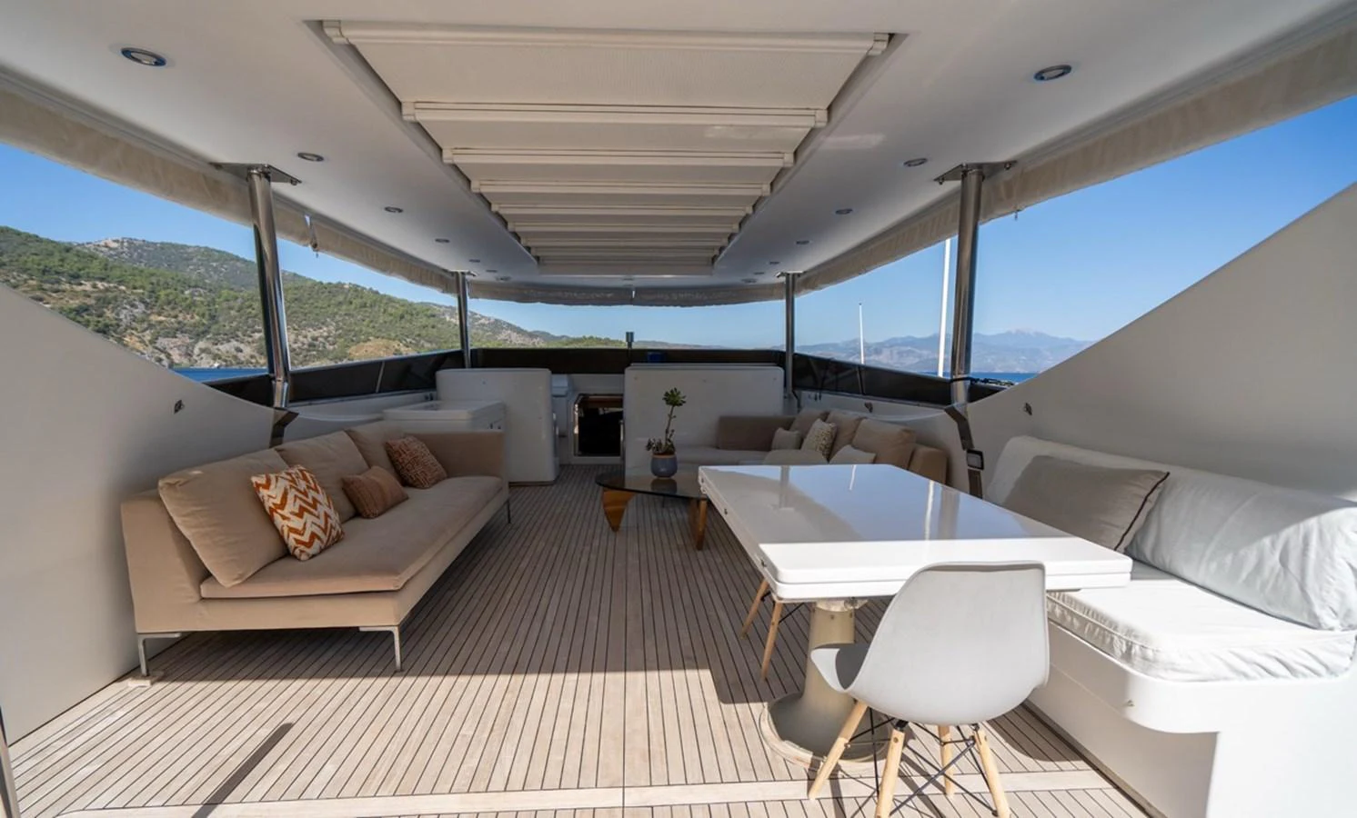 a room with a couch and a table and a window aboard ADMIRAL 27 M Yacht for Sale