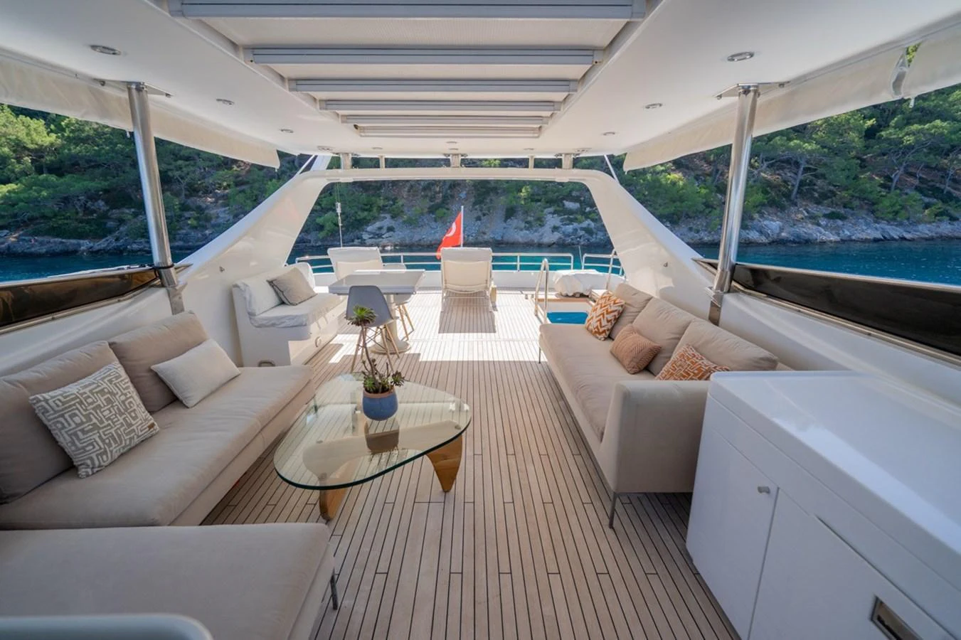 a living room with a large patio aboard ADMIRAL 27 M Yacht for Sale