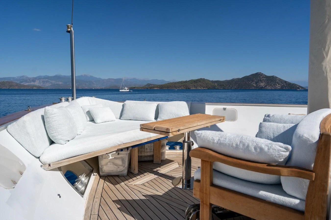 a deck with a view of the ocean and mountains in the background aboard ADMIRAL 27 M Yacht for Sale
