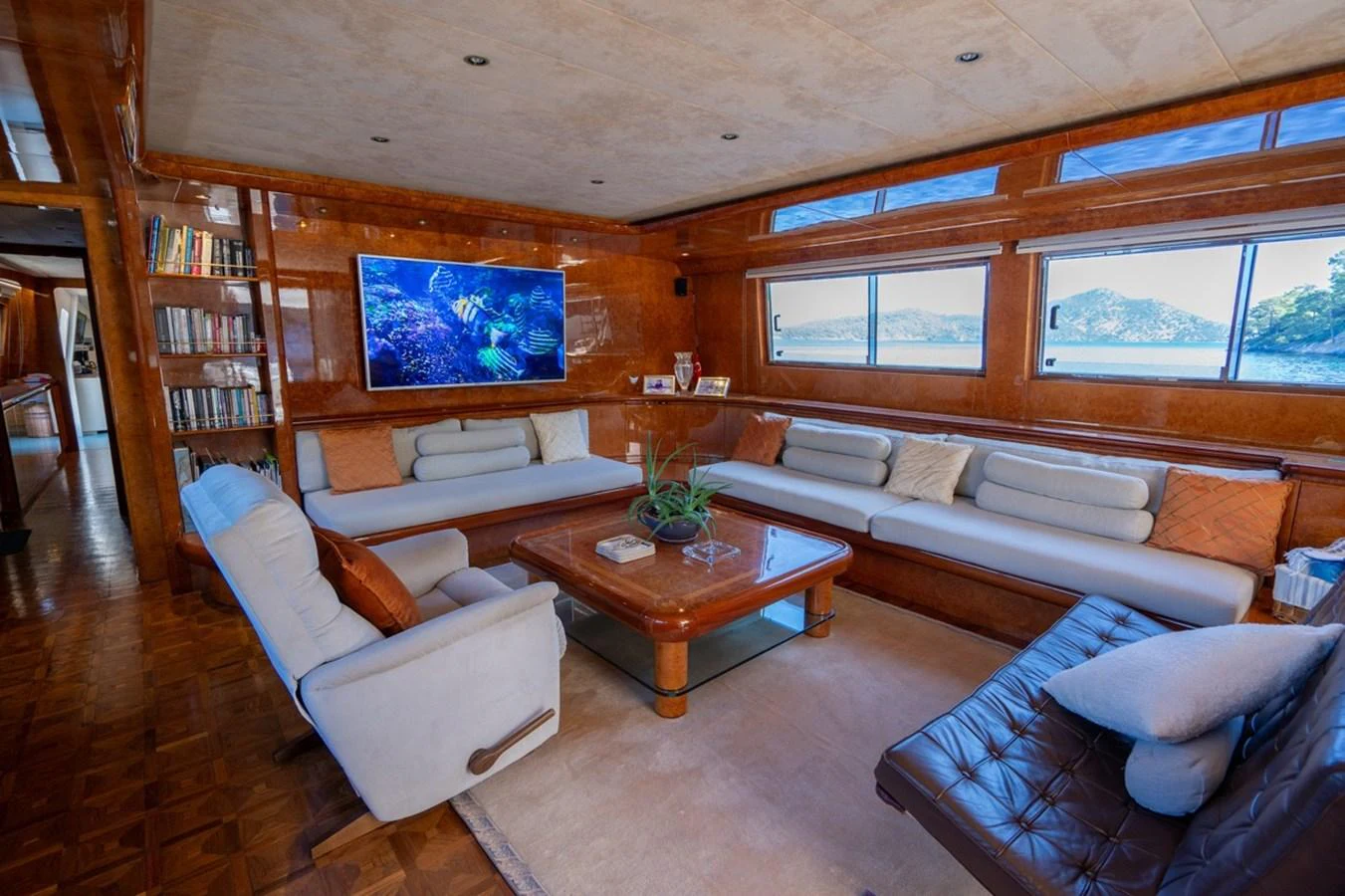 a living room with a couch and a coffee table aboard ADMIRAL 27 M Yacht for Sale