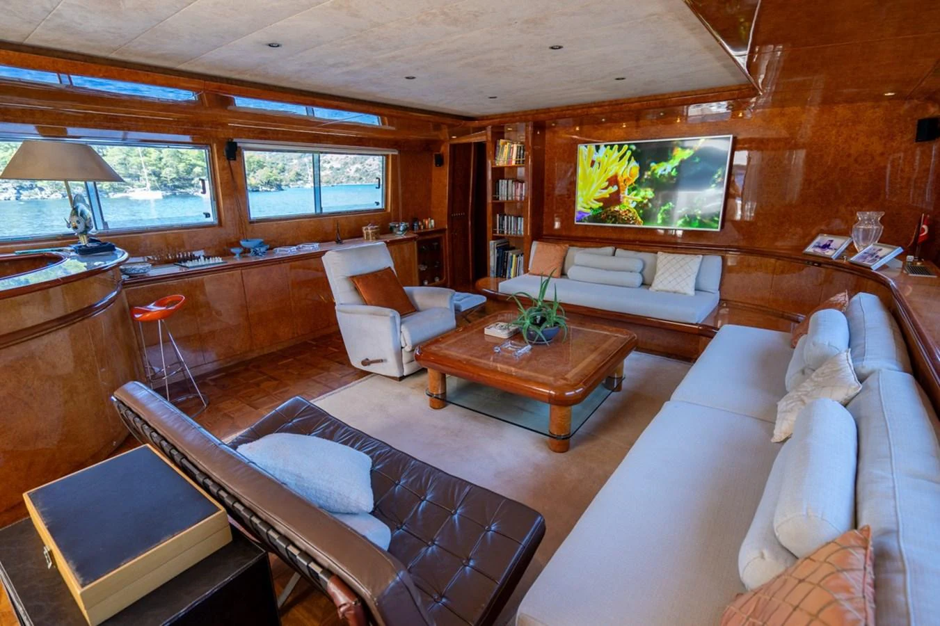 a living room with a large screen aboard ADMIRAL 27 M Yacht for Sale
