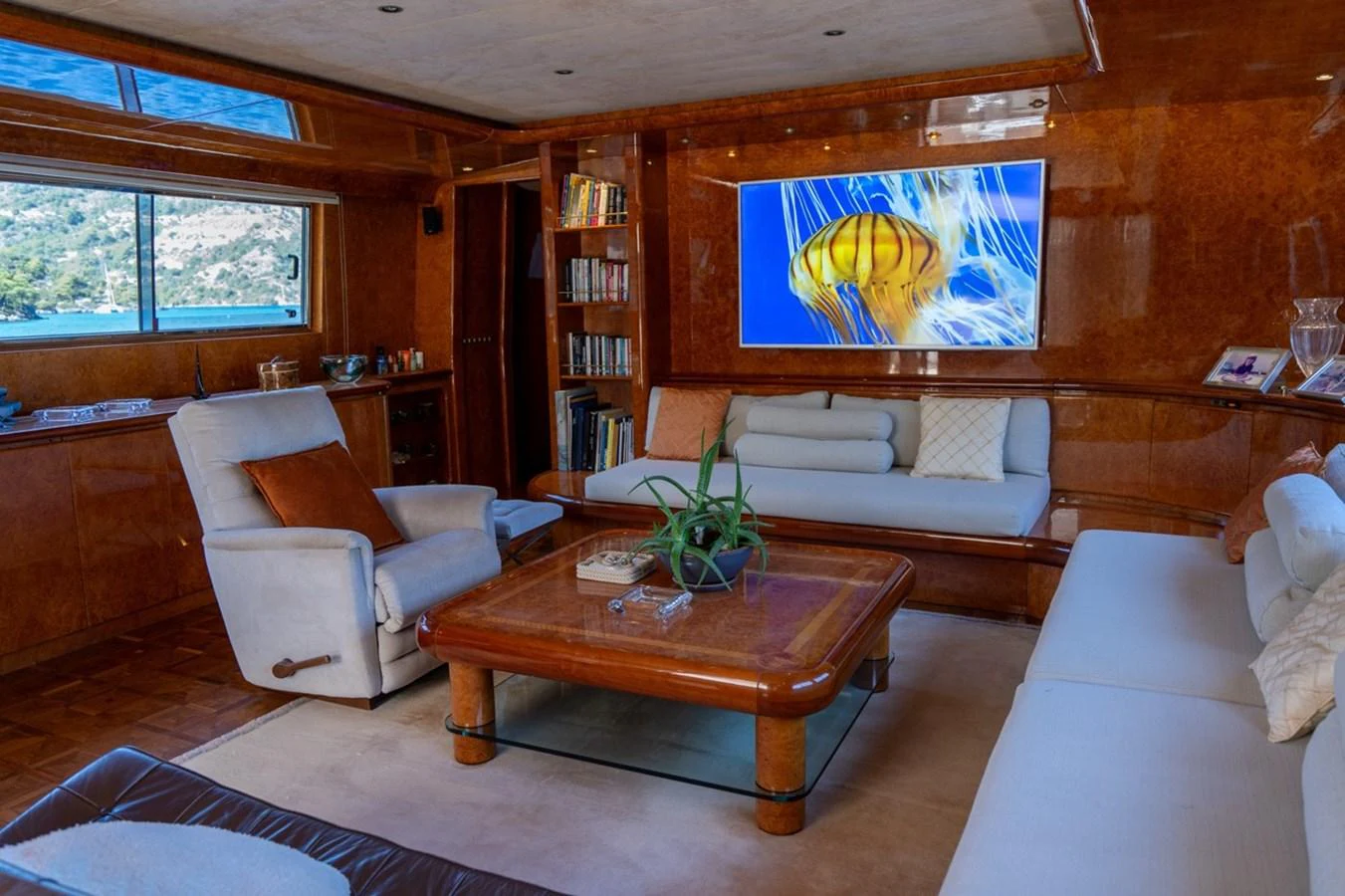 a living room with a table and couches aboard ADMIRAL 27 M Yacht for Sale