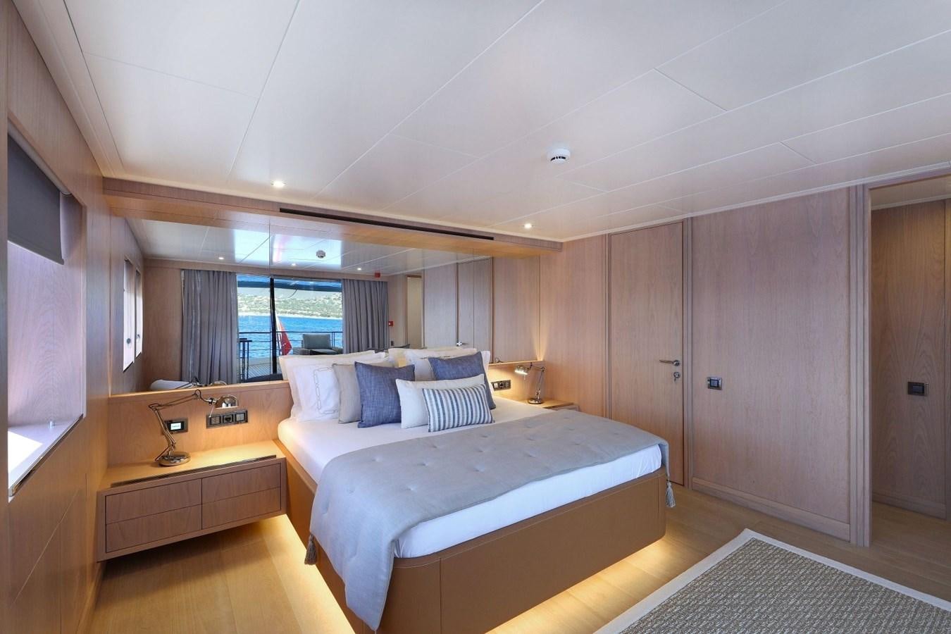 a bedroom with a bed and a desk aboard TORTURA Yacht for Sale
