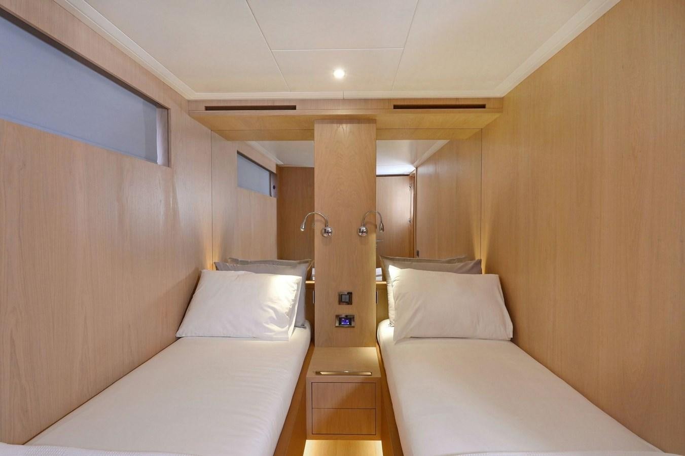 a room with two beds aboard TORTURA Yacht for Sale
