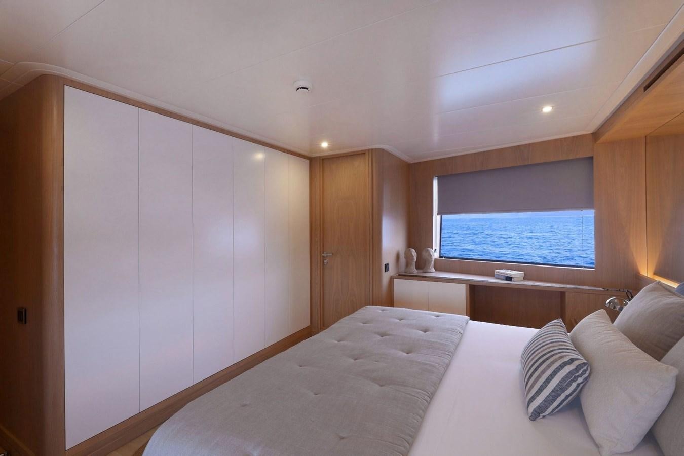 a bedroom with a large bed aboard TORTURA Yacht for Sale