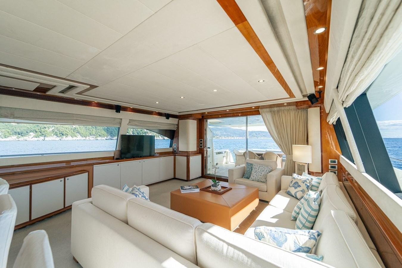 a living room with a couch and a table aboard LADY HELENA Yacht for Sale
