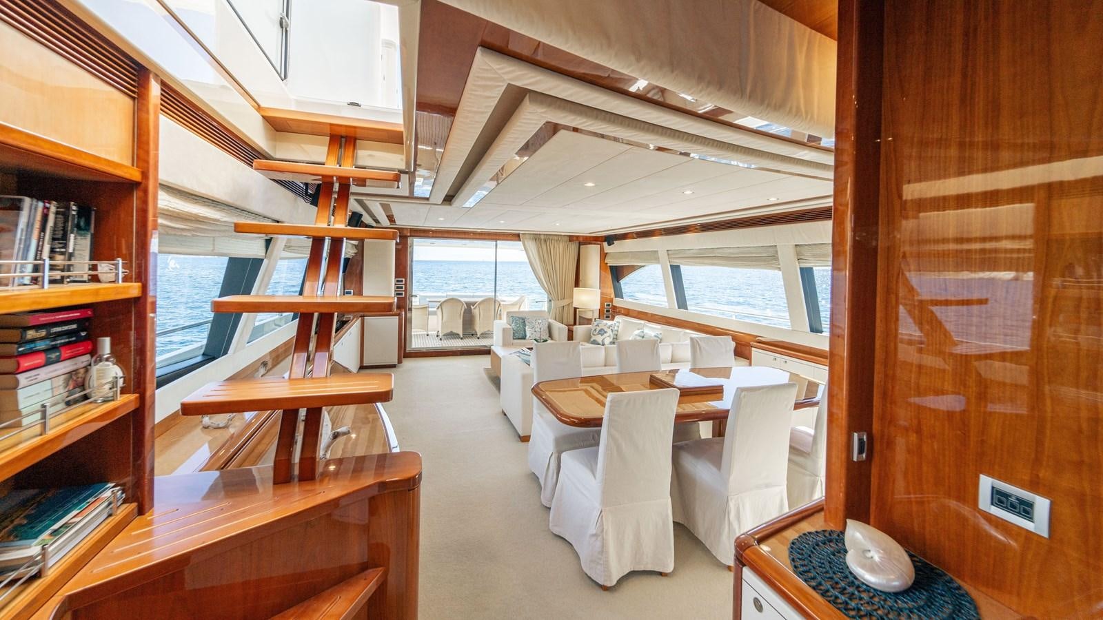 a room with a table and chairs aboard LADY HELENA Yacht for Sale