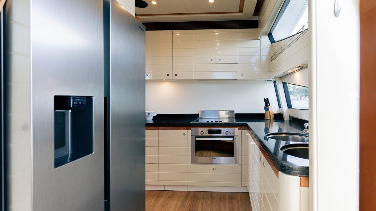 a kitchen with white cabinets aboard LADY HELENA Yacht for Sale