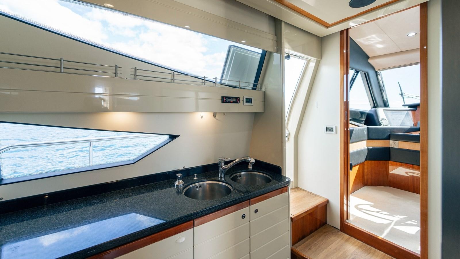 a kitchen with a sink and a tv aboard LADY HELENA Yacht for Sale