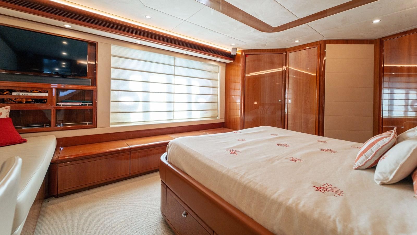 a room with a bed and a television aboard LADY HELENA Yacht for Sale