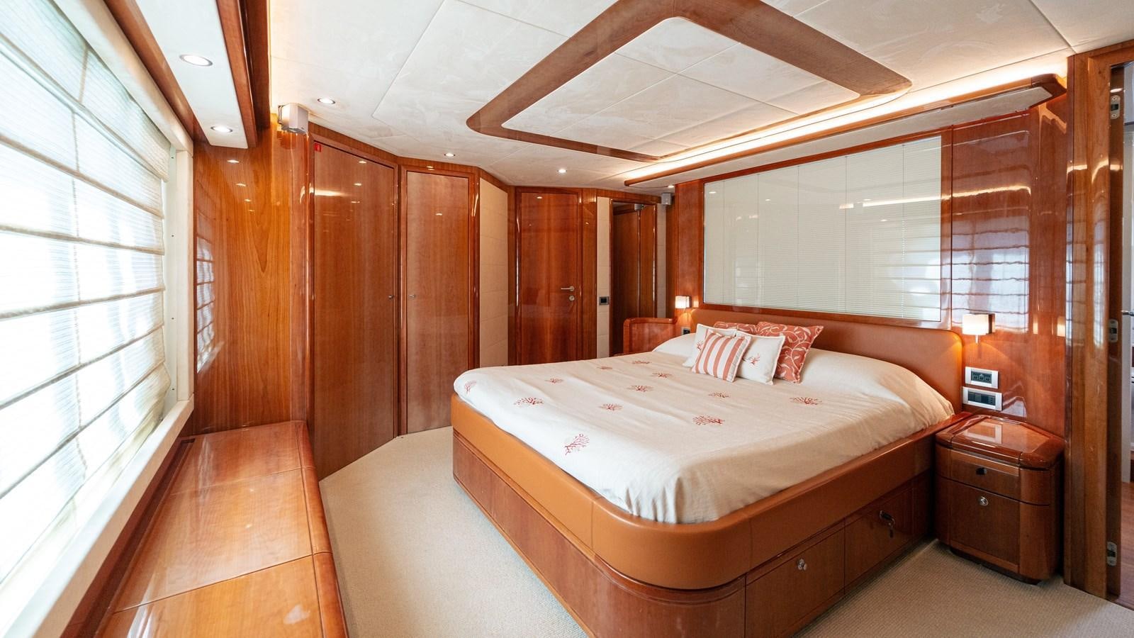 a bedroom with a bed and a window aboard LADY HELENA Yacht for Sale