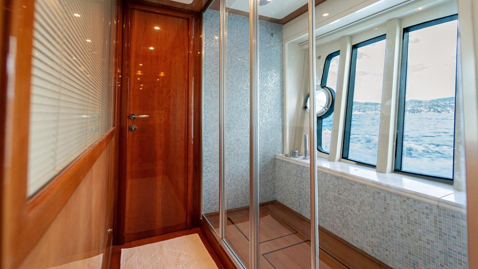 a room with a glass door aboard LADY HELENA Yacht for Sale