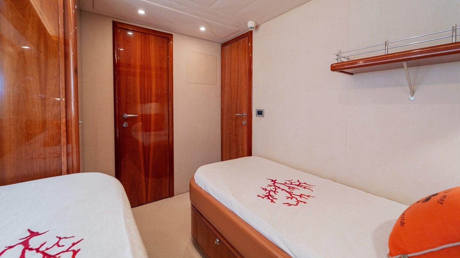 a room with a bed and a door aboard LADY HELENA Yacht for Sale
