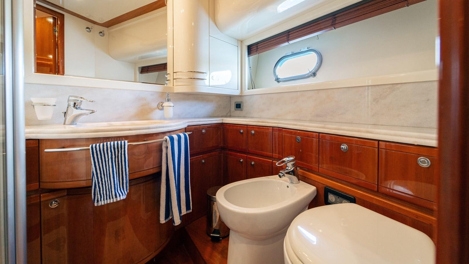 a bathroom with a sink and a toilet aboard LADY HELENA Yacht for Sale