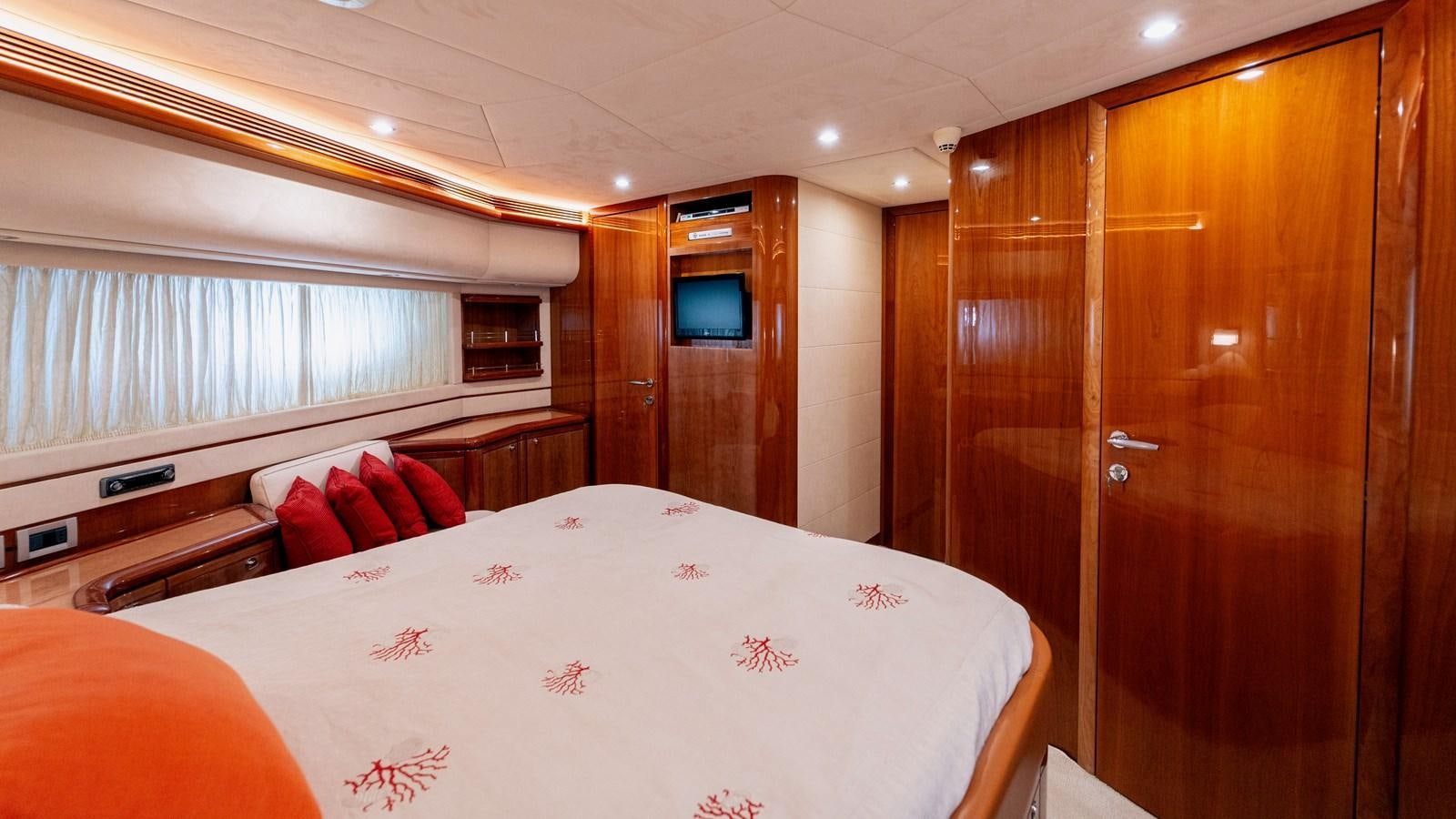 a room with a bed and a wood cabinet aboard LADY HELENA Yacht for Sale