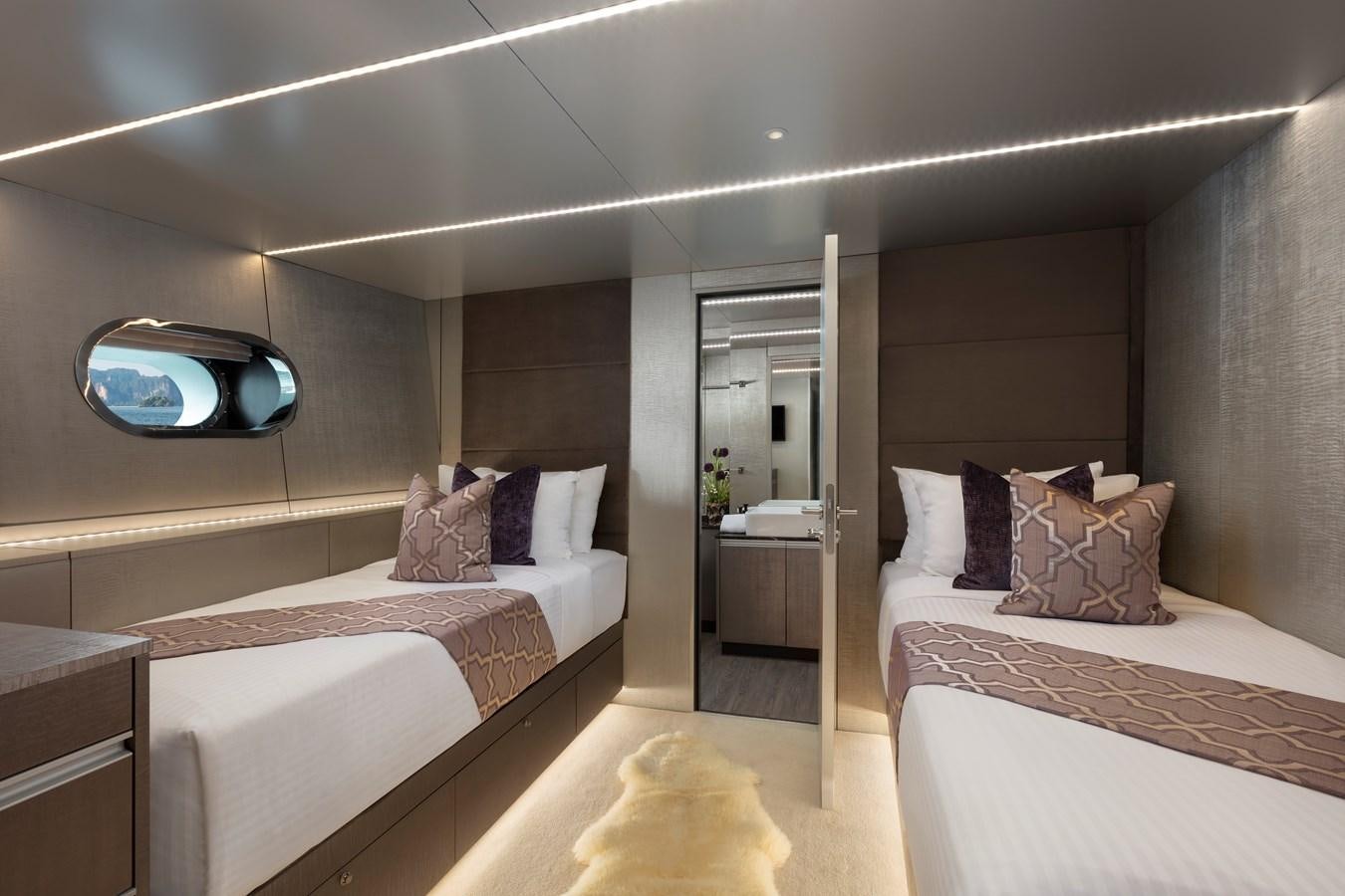 a room with a bed and a mirror aboard OCEAN EMERALD Yacht for Sale
