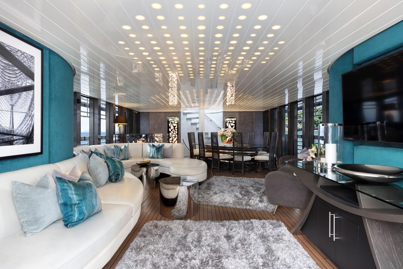 a living room with a large chandelier aboard OCEAN EMERALD Yacht for Sale