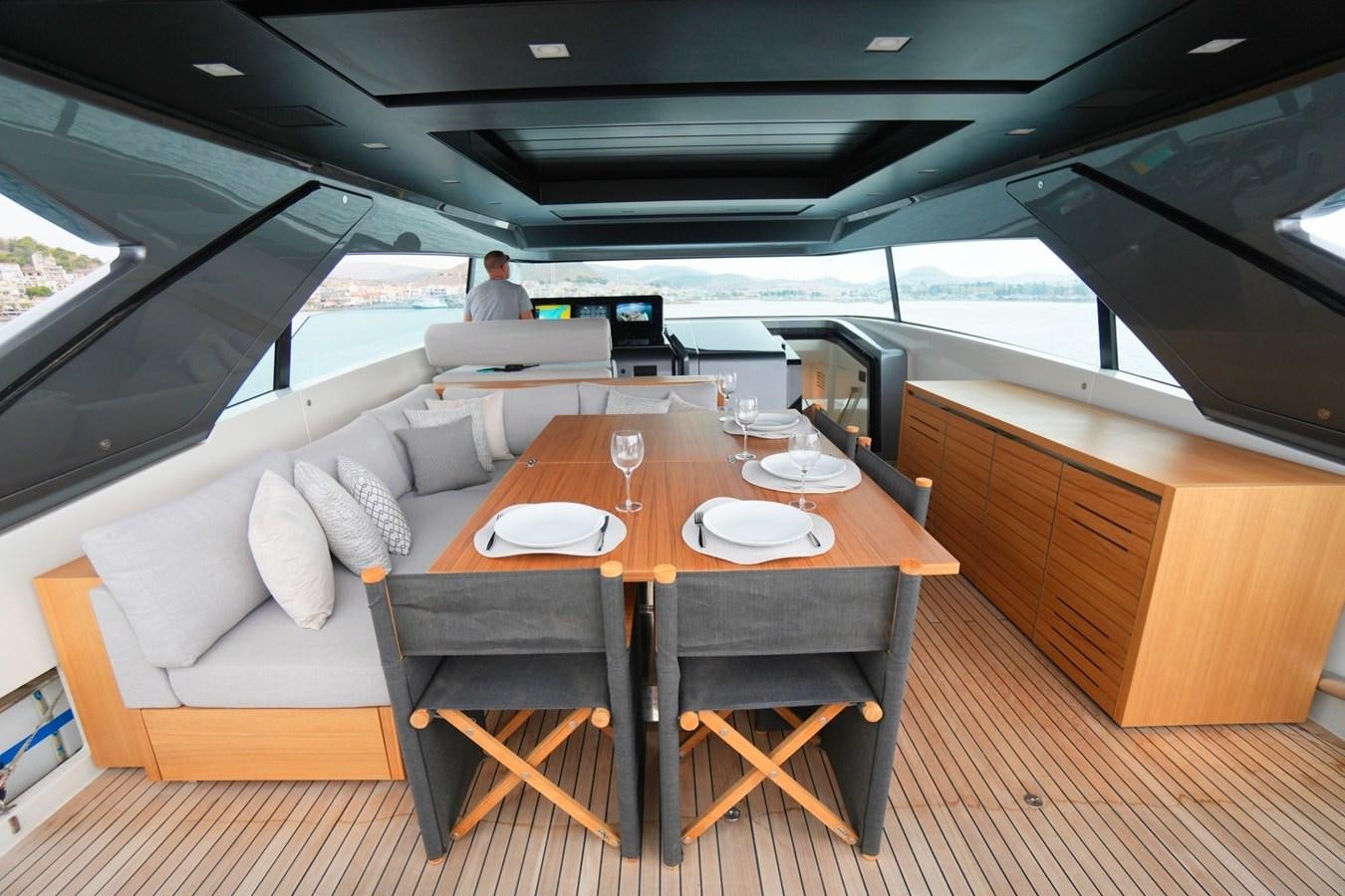 a table with plates and chairs aboard LOVE IS IN THE AIR Yacht for Sale