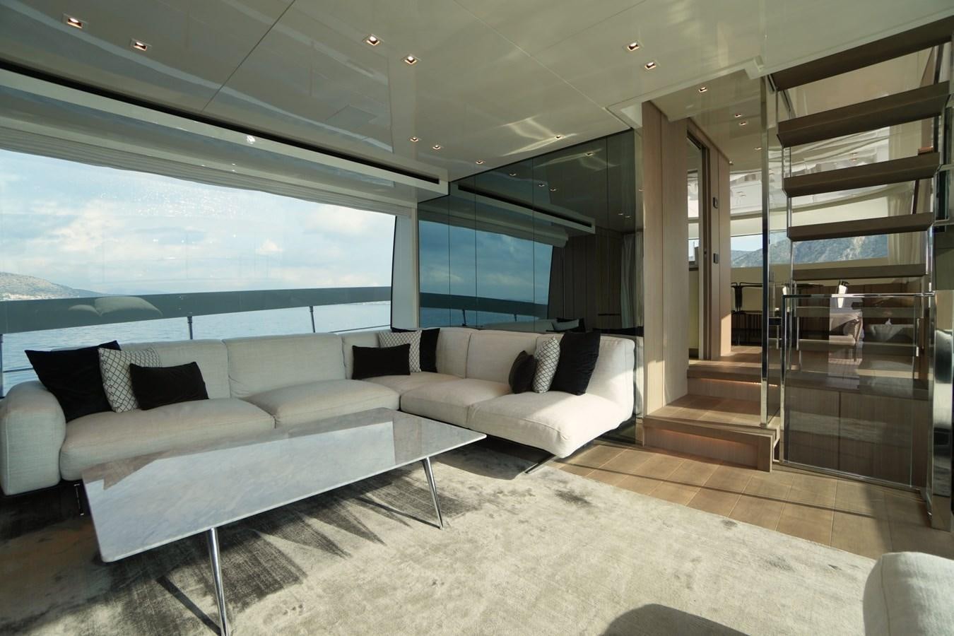 a living room with a glass wall aboard LOVE IS IN THE AIR Yacht for Sale