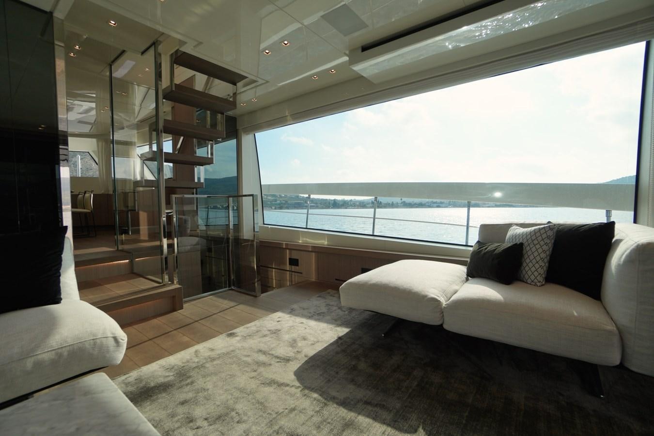 a room with a couch and a view of the ocean aboard LOVE IS IN THE AIR Yacht for Sale