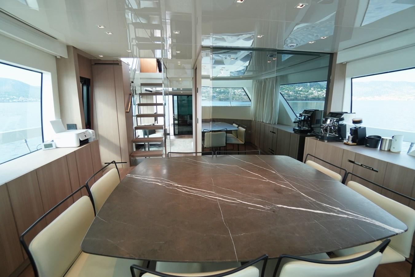 a room with a table and chairs aboard LOVE IS IN THE AIR Yacht for Sale