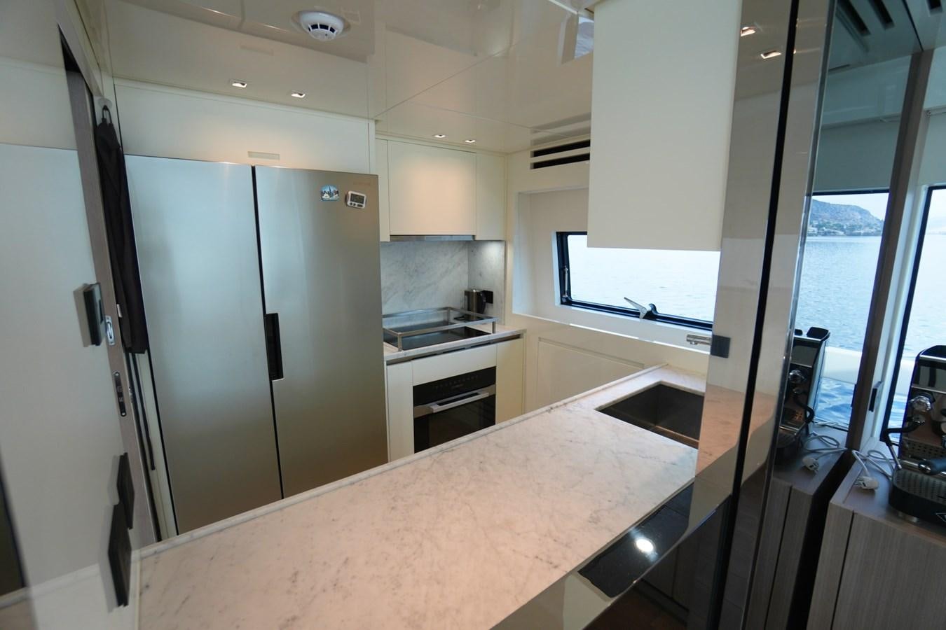 a kitchen with a large island aboard LOVE IS IN THE AIR Yacht for Sale