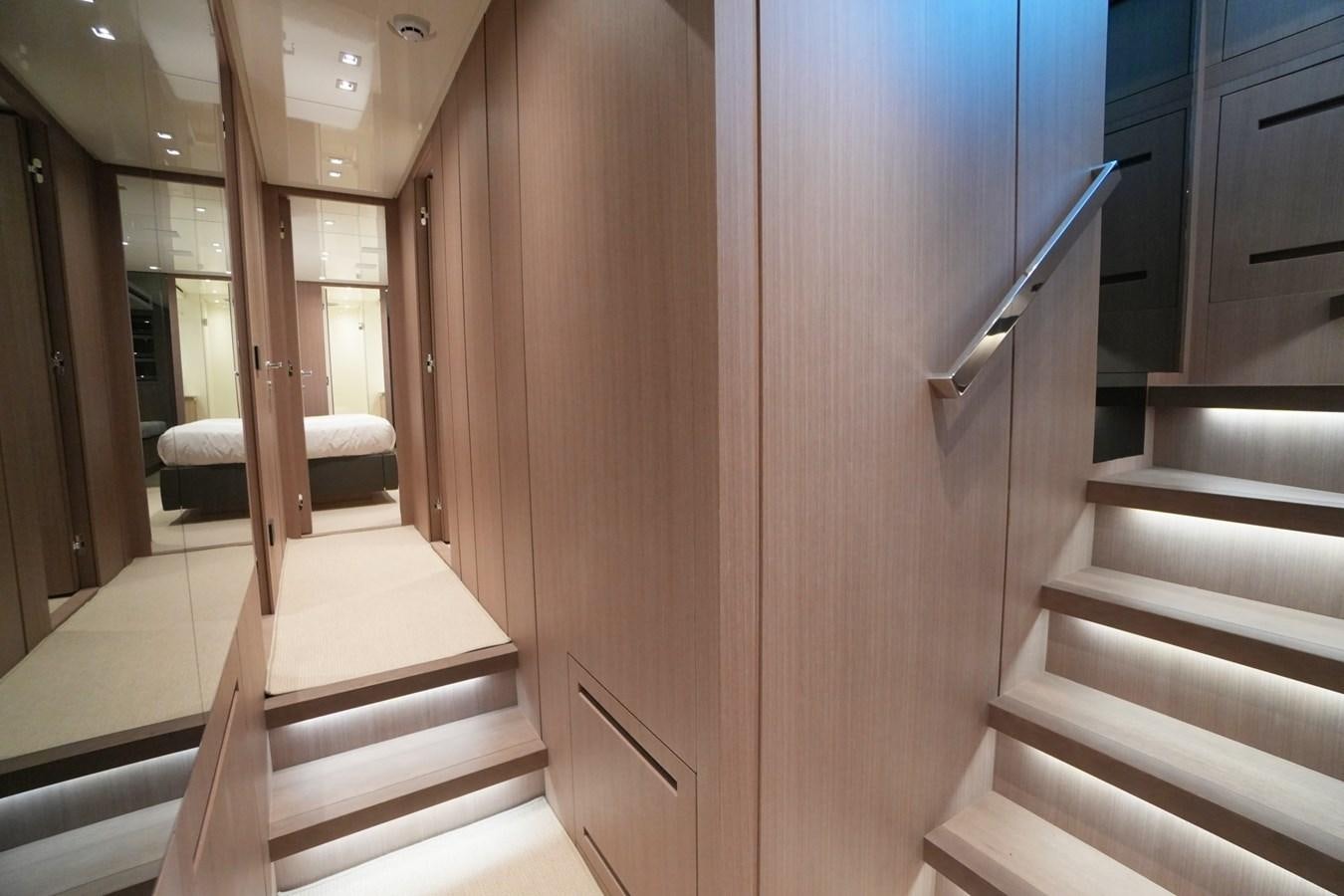 a hallway with a door and a bed aboard LOVE IS IN THE AIR Yacht for Sale