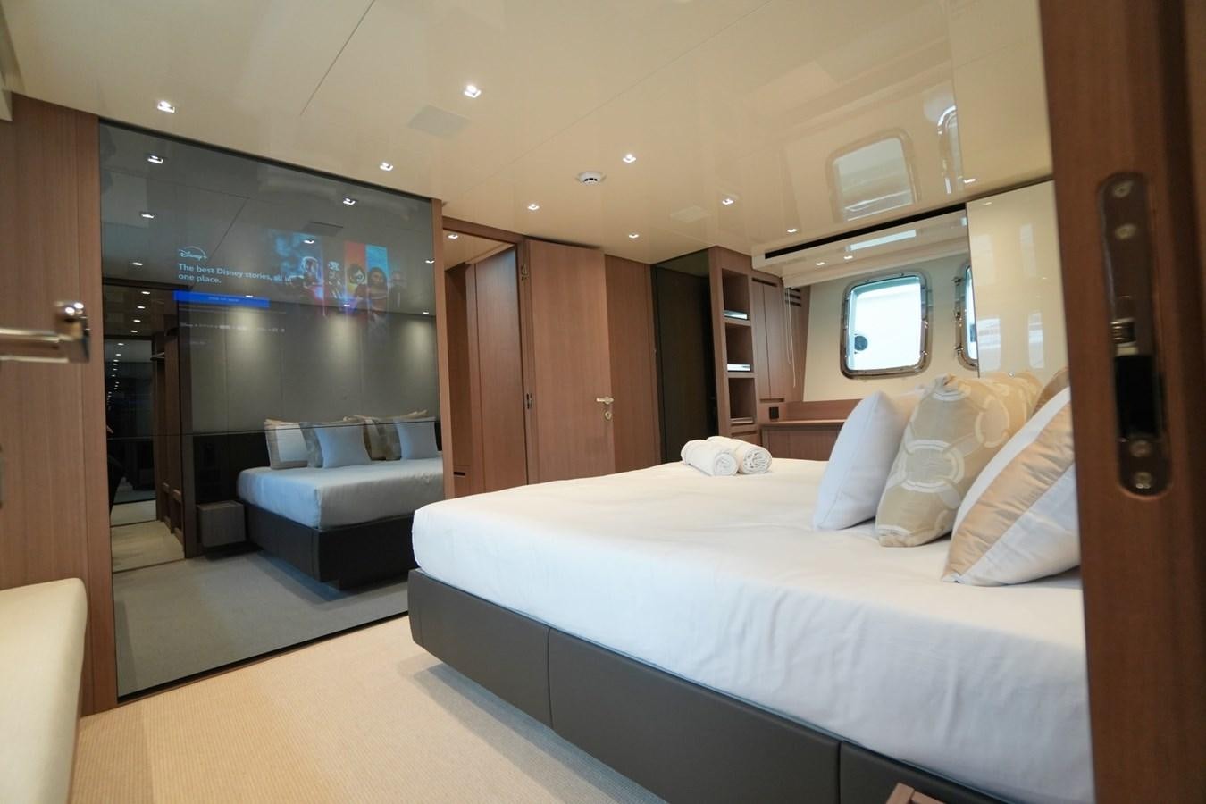 a hotel room with a bed and a television aboard LOVE IS IN THE AIR Yacht for Sale