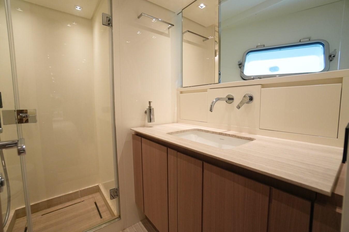 a bathroom with a sink and a tv on the wall aboard LOVE IS IN THE AIR Yacht for Sale