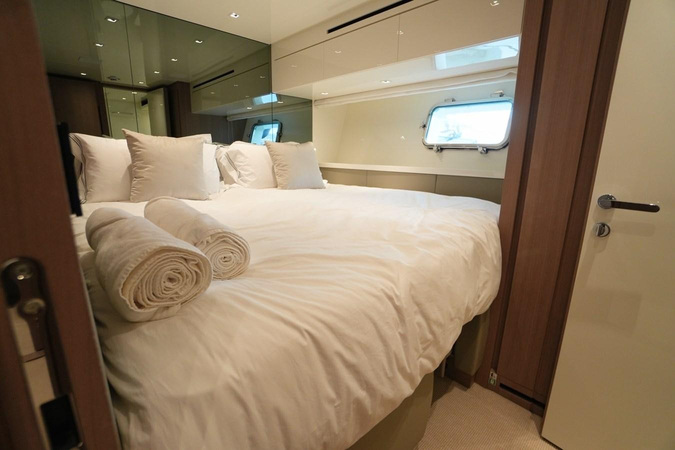 a bed with white sheets aboard LOVE IS IN THE AIR Yacht for Sale