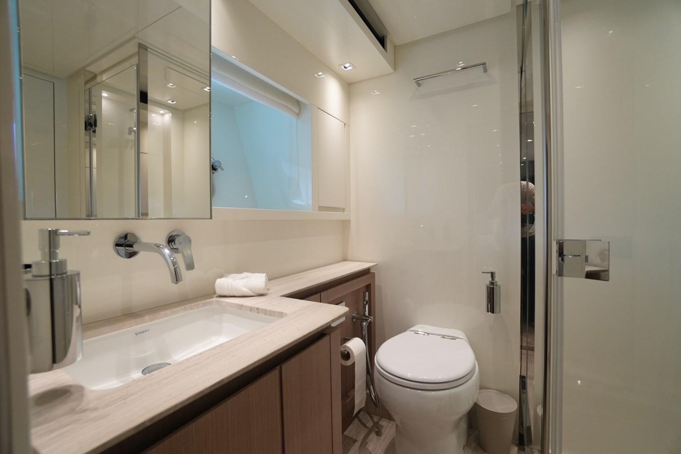 a bathroom with a sink toilet and a mirror aboard LOVE IS IN THE AIR Yacht for Sale