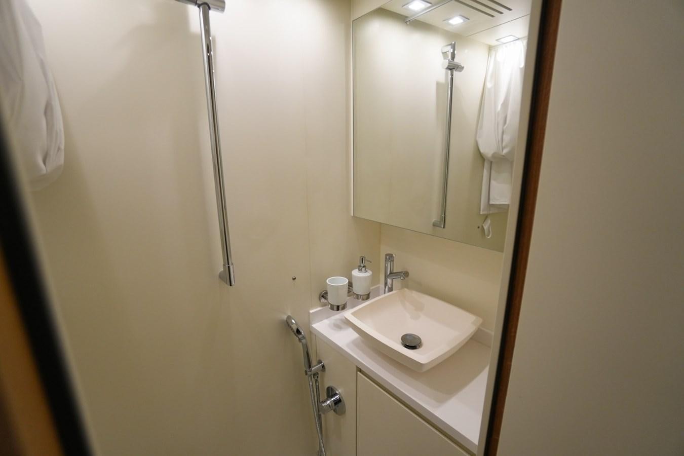 a bathroom with a sink and a mirror aboard LOVE IS IN THE AIR Yacht for Sale