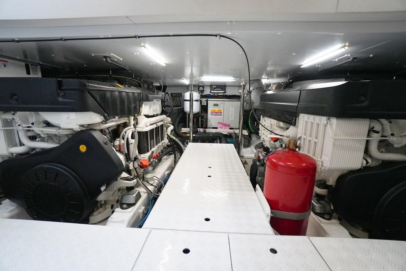 a large machine with a red and white cylinder on the side aboard LOVE IS IN THE AIR Yacht for Sale