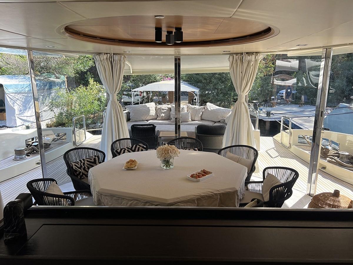 a table with a white cloth on it in a room with a window aboard AZIMUT 98 2009 Yacht for Sale