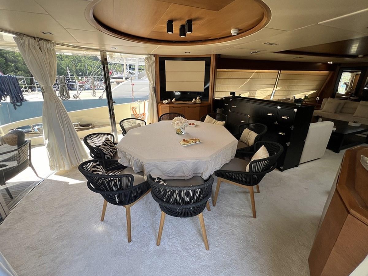 a large living room with a large table and chairs aboard AZIMUT 98 2009 Yacht for Sale