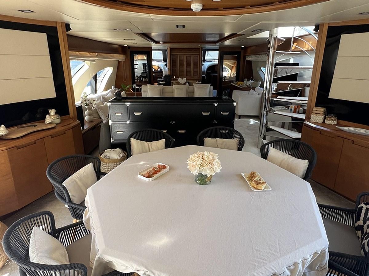 a dining room with a large white table and chairs aboard AZIMUT 98 2009 Yacht for Sale