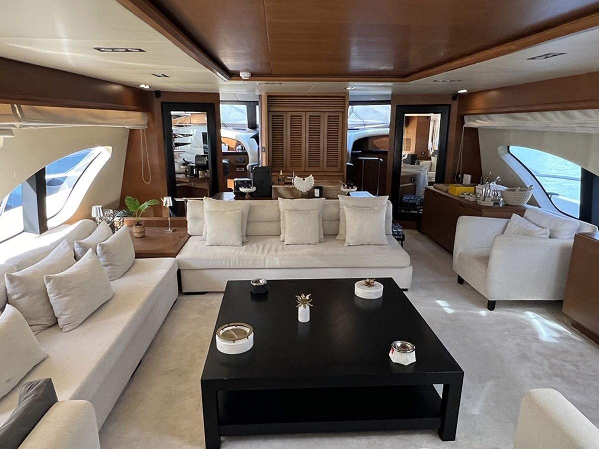 a living room with a large sofa and a coffee table aboard AZIMUT 98 2009 Yacht for Sale