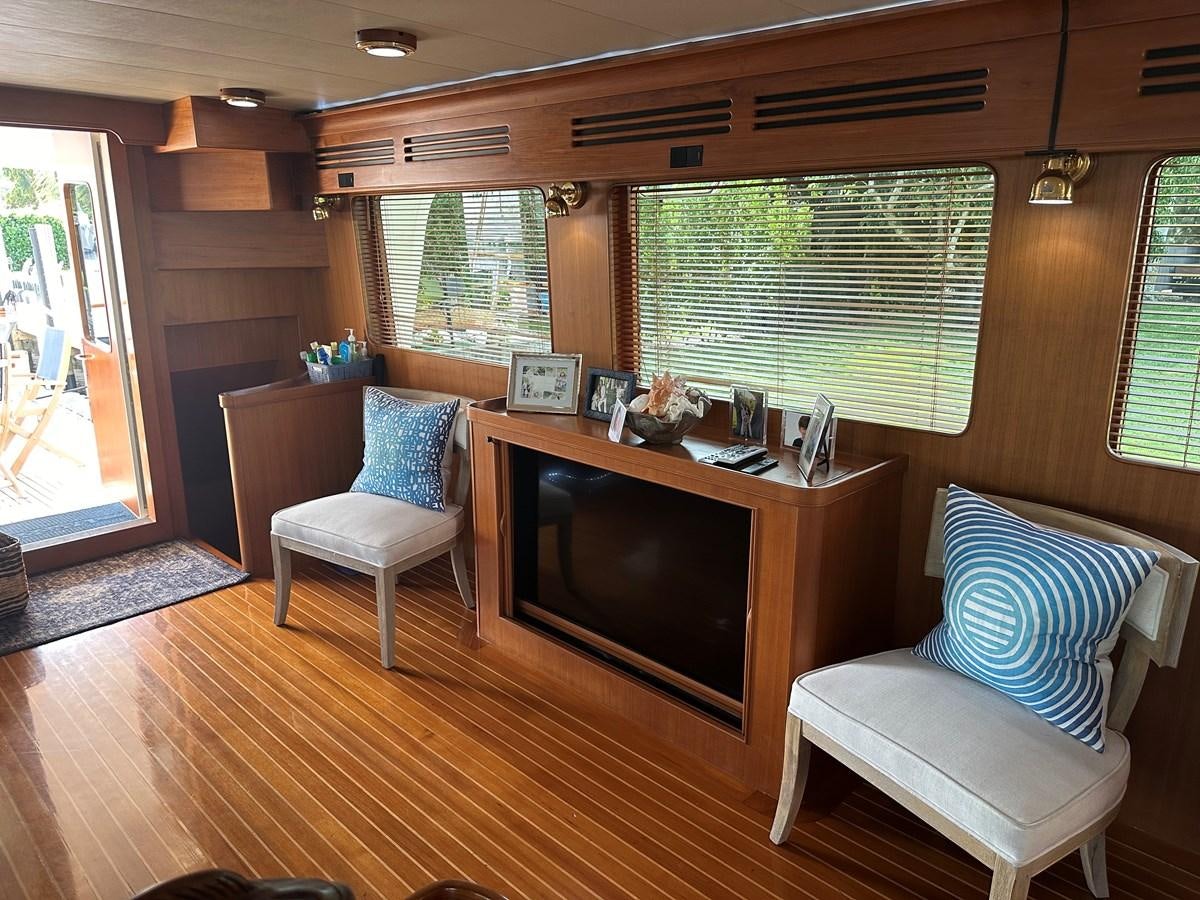 a living room with a fireplace aboard BANDOL Yacht for Sale