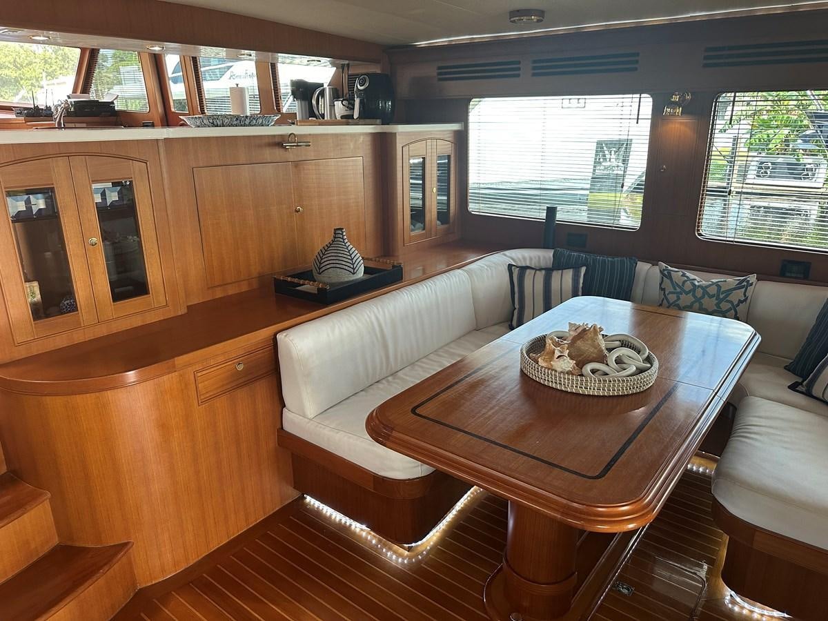 a living room with a table and couches aboard BANDOL Yacht for Sale
