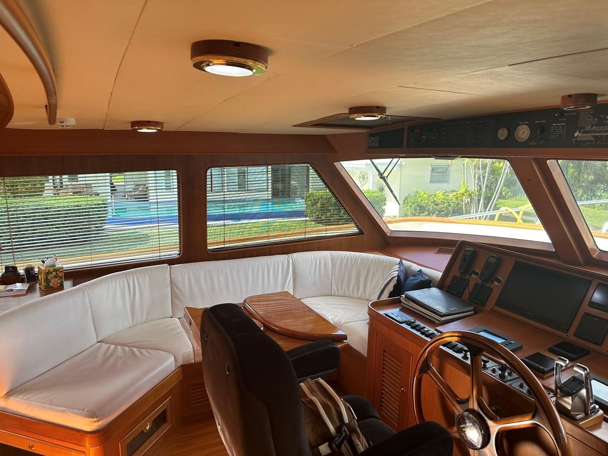a room with a bed and a desk with a laptop on it aboard BANDOL Yacht for Sale