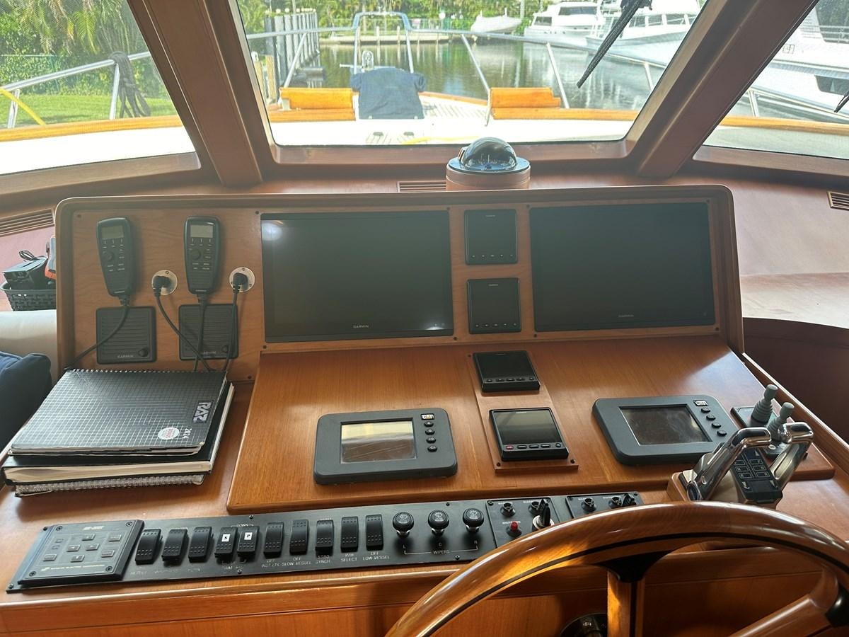 a desk with a laptop and a phone on it aboard BANDOL Yacht for Sale