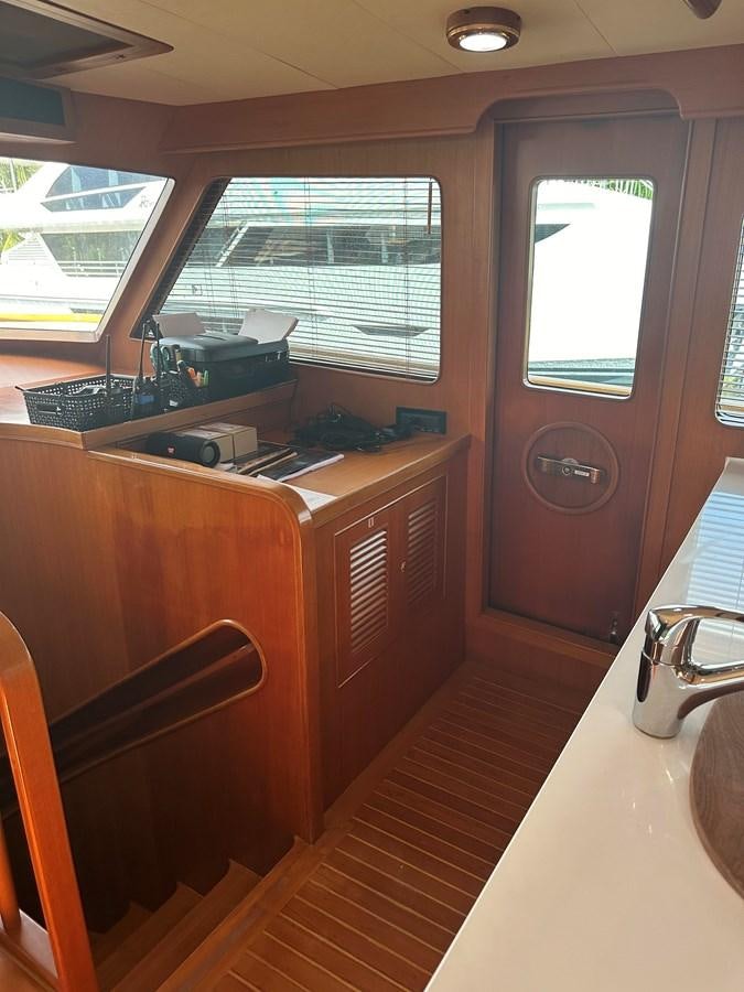 a kitchen with a wood floor aboard BANDOL Yacht for Sale