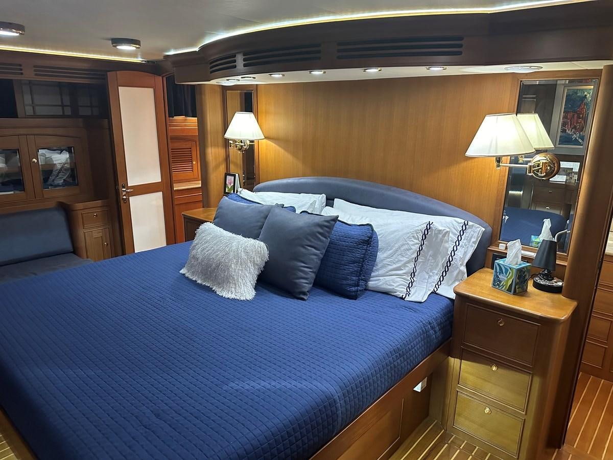 a bed with blue sheets aboard BANDOL Yacht for Sale