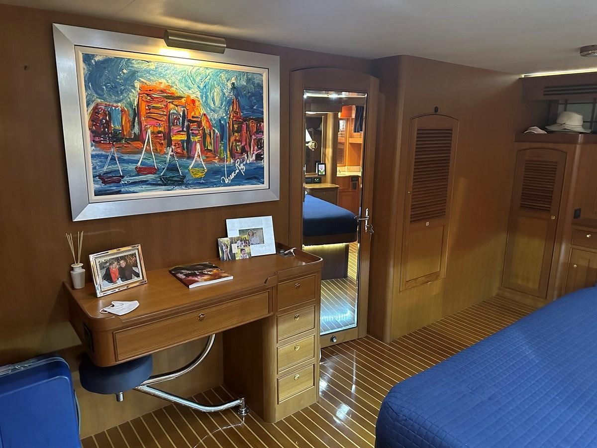 a room with a desk and a bed aboard BANDOL Yacht for Sale