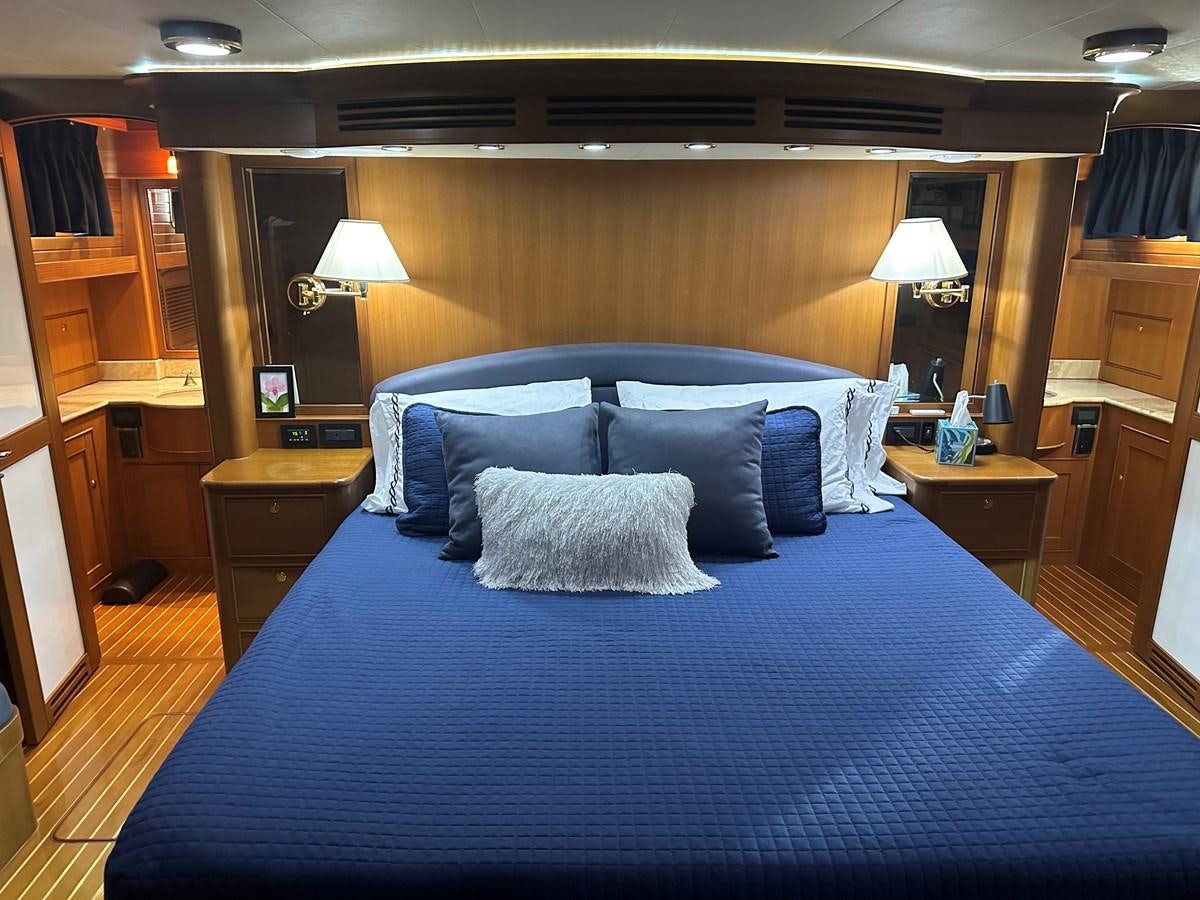 a bed with a blue comforter aboard BANDOL Yacht for Sale