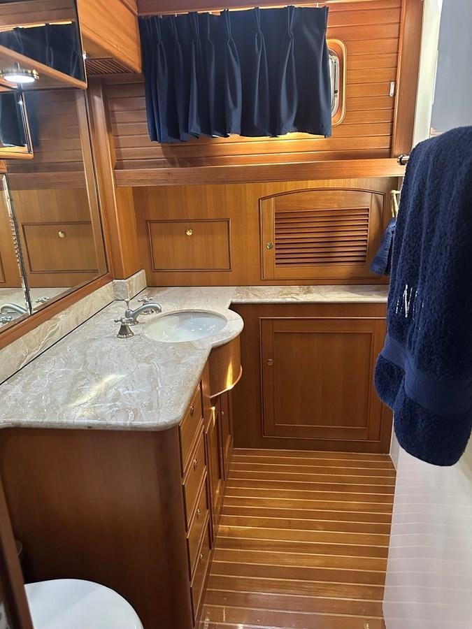 a bathroom with a sink and a mirror aboard BANDOL Yacht for Sale