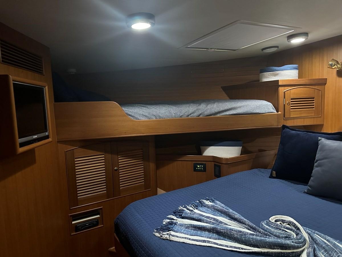 a room with a bed and a television aboard BANDOL Yacht for Sale