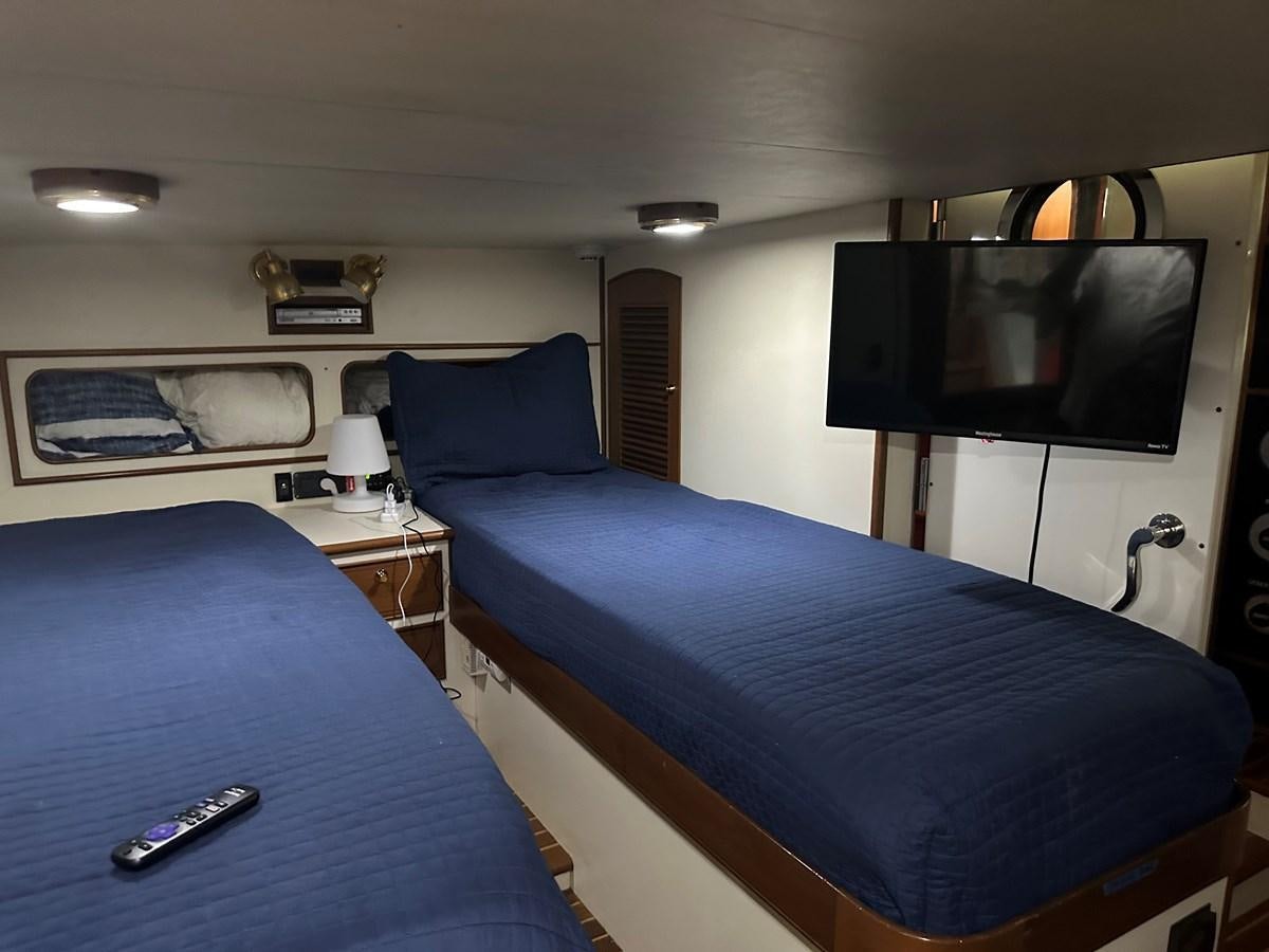 a room with a bed and a television aboard BANDOL Yacht for Sale